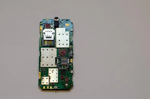 Disassembled mobile phone on the table of a mechanical engineer during repair Stock Photos