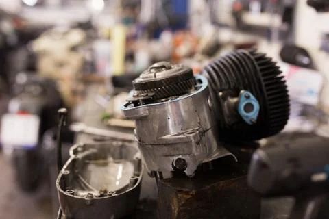 Disassembled motorcycle engine on a table in workshop 写真素材