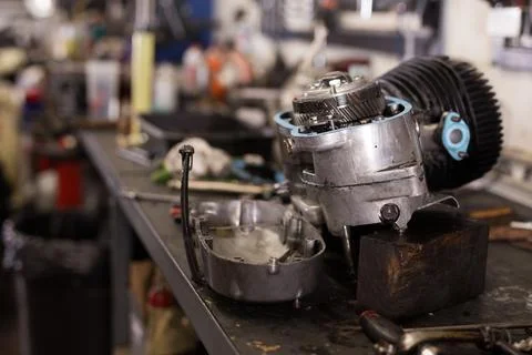 Disassembled motorcycle engine on a table in workshop Fotos de archivo
