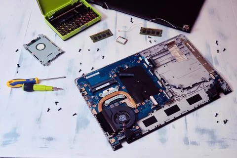 Disassembled notebook on white background. Checking the processor and motherb 库存照片