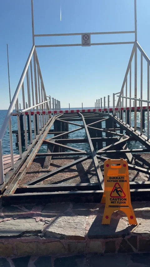 A disassembled pier for sea bathing at the end of the summer season, with cal Stock Footage 303359205