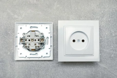 Disassembled power socket on grey table, flat lay Stock Photos