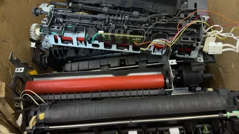 Disassembled printer parts with rollers, gears and wires in cardboard box Stock-Footage 342438175