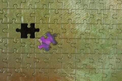 Disassembled puzzle with a last wrong piece impossible to fill Stock Photos