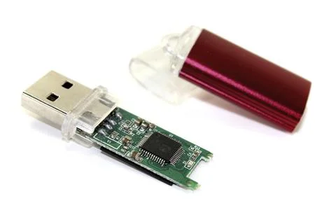 Disassembled red USB stick on a light-coloured background Stock Photos
