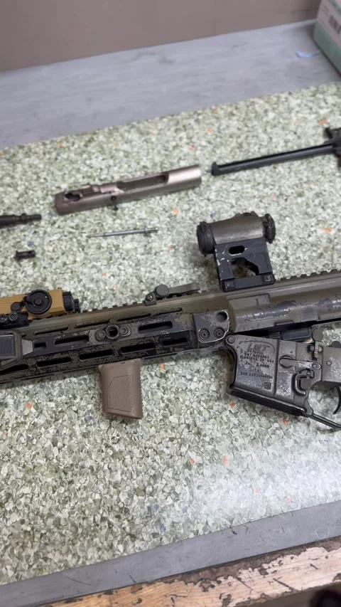 Disassembled rifle and weapon components on work surface Stock Footage 327072074
