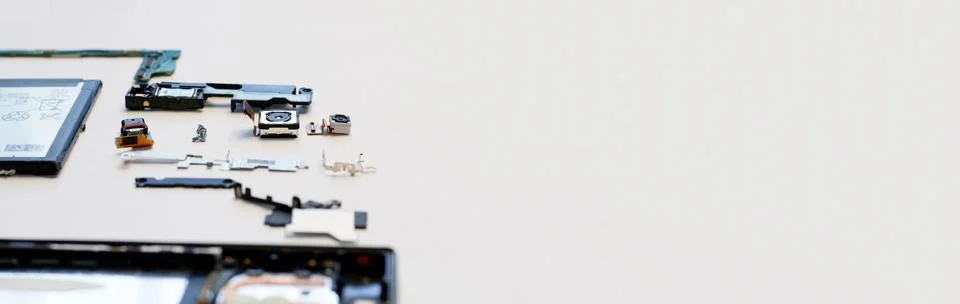 Disassembled smartphone components on a white background. Electronic parts,.. Stock Photos