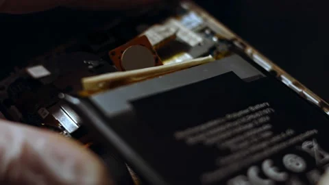 Disassembled smartphone. Technician replacing old battery, electronics repair Stock Footage 143166971