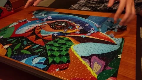 Disassembling complete jigsaw puzzle in slow motion Stock Footage 252224422
