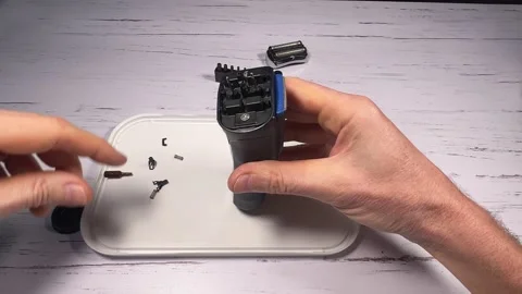 Disassembling an electric shaver beard and replacing batteries - step 10 of 10 Stock Footage 327304919