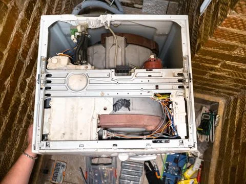 Disassembling an old washing machine at home Stock Photos