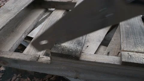 Disassembling pallet with a saw for the reclaimed lumber. Stock Footage 143063378
