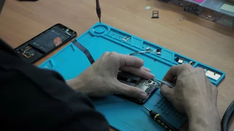 Disassembling the phone in the workshop Stock Footage 139423158