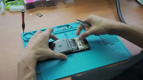 Disassembling the phone in the workshop Stock Footage 139423159