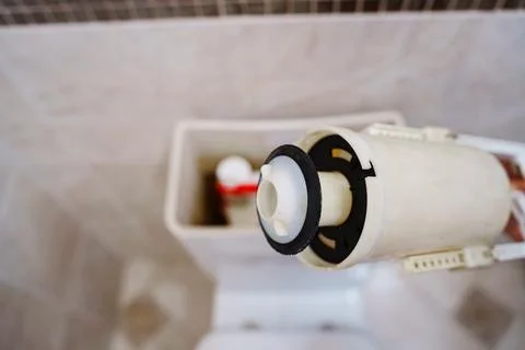 Disassembling the toilet tank. Stock Photos