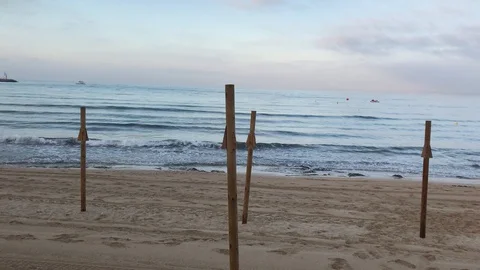 Disassembling the umbrellas on the beach Stock Footage 128132319
