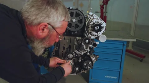 Disassembly of a car engine, the master disassembles the car engine Stock Footage 304064713