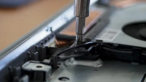Disassembly of the laptop cooling system. Removing the turbine of the cooling Stock Footage 297071080