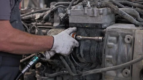 Disassembly of a large diesel engine using an air wrench. Stock Footage 261289016