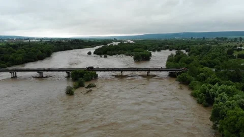 Disaster. Cataclysm. Catastrophe.Fast flowing raging river.Swollen boiling Stock Footage 133451701