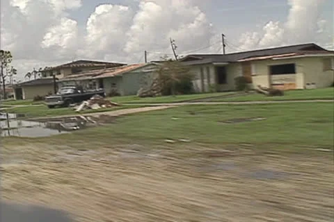 Disaster, Corner turn, drive by damaged houses-8 Hurricane Andrew damage 1992 Stock Footage 25826984