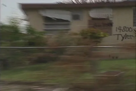 Disaster, Drive by quick zoom out badly damaged houses, police car turns corner Stock Footage 25827545