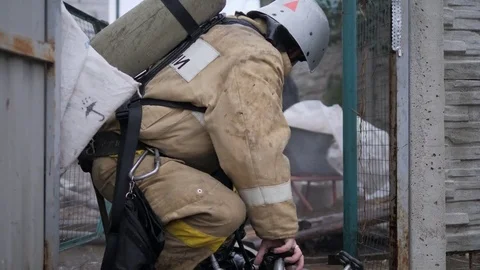 Disaster. A firefighter works on a fire. Fire in a private house Stock Footage 80838836