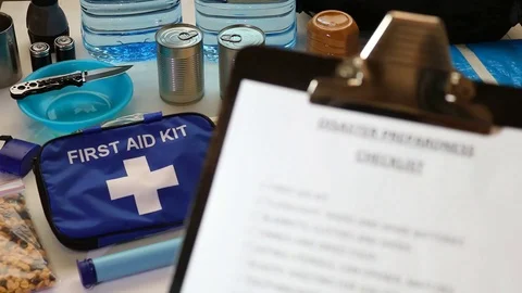 Disaster preparation hand ticking off items on clipboard checklist. HD Stock-Footage 129553047