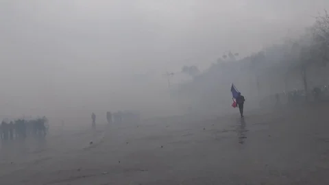 Disastrous scene of riot's aftermath in Paris with man holding France flag Stock Footage 103183663