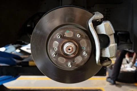 Disc brake of a car to be fixed at garage Stock Photos