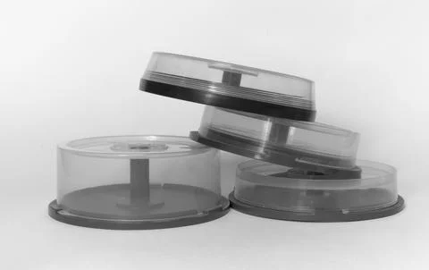 Disc cake box. pile of transparent storages with spindel for CDs in black a.. Stock Photos
