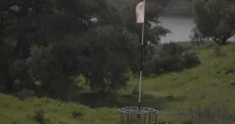 Disc golf basket on grassy course Stock Footage 104460337