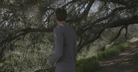 Disc golf drive throw on tee pad under trees Stock Footage 104460188