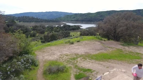 Disc golf drive off Top of the World, Lake Casitas Stock Footage 104459836