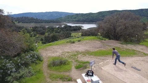 Disc golf drive off Top of the World, Lake Casitas Stock Footage 104459882