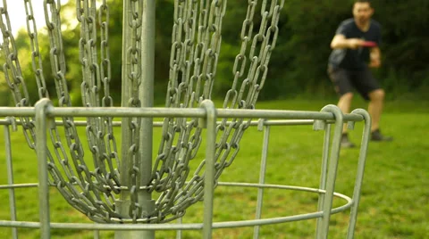 Disc Golf Player Throwing Into The Basket Stock Footage 39374863