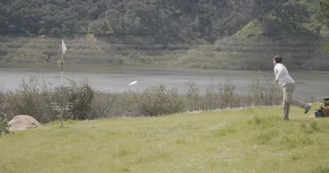 Disc golf putt attempt, Hole 7 Coyote Point, Lake Casitas, California Stock Footage 104460360