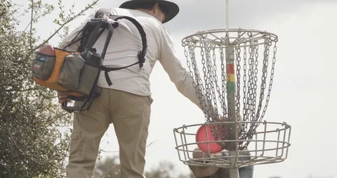 Disc golf putting into basket Video stock 104460423
