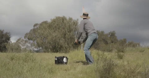 Disc golf putting into basket Stock Footage 104460571