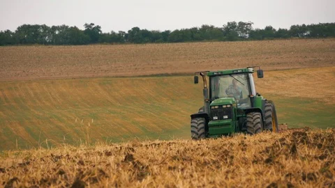 Disc harrow farming implement harrowing dry soil in slow motion Stock-Footage 95392383