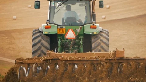 Disc harrow farming implement harrowing dry soil Stock Footage 95392485