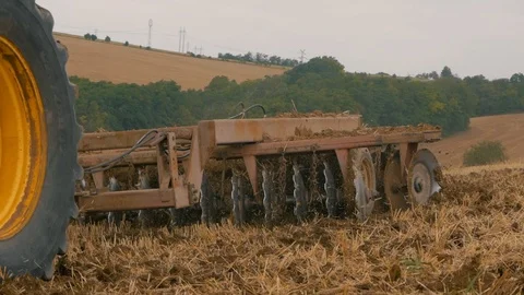 Disc harrow farming implement harrowing dry soil Stock Footage 95392835
