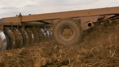Disc harrow farming implement harrowing dry soil Stock Footage 95392875