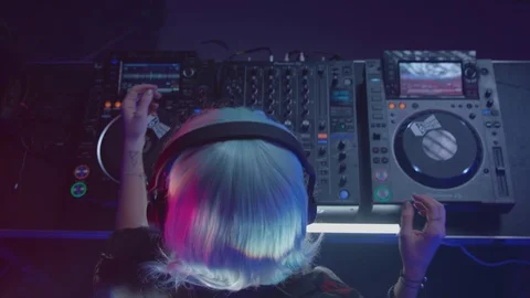 Disc jockey dancing while playing music in the nightclub Stock Footage 87159729