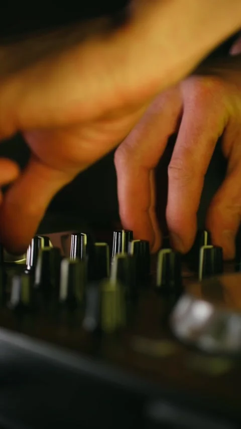 Disc jockey hands adjusting knobs on music mixer 動画素材 337830662