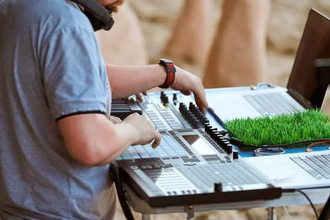 Disc jockeys DJs hands playing music on drum machine midi controller, beat sa Stock Photos