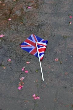 Discarded British flag lying in a puddle Stock Photos
