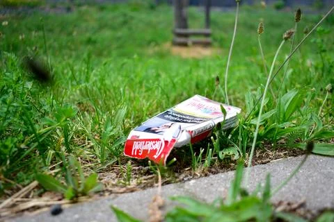 Discarded Cigarette Pack on Grass Stock Photos