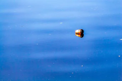 Discarded Coffee Cup Floating in River Water Stock Photos