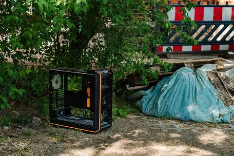 Discarded computer case beside construction site on a sunny day Stock Photos